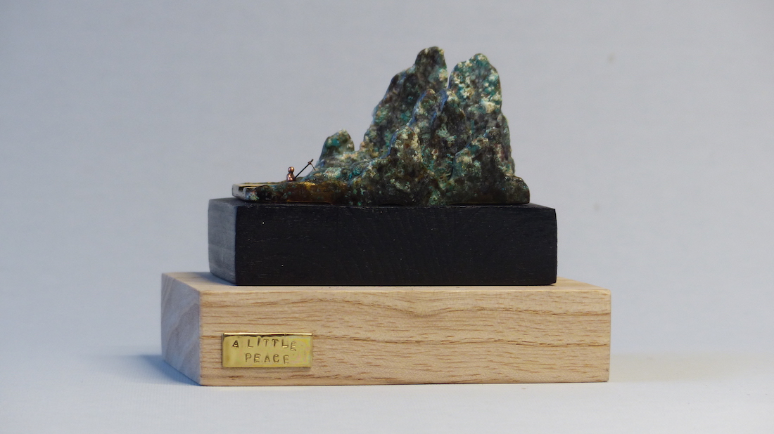 Green patinated brass mountain and fisherman ring sculpture front