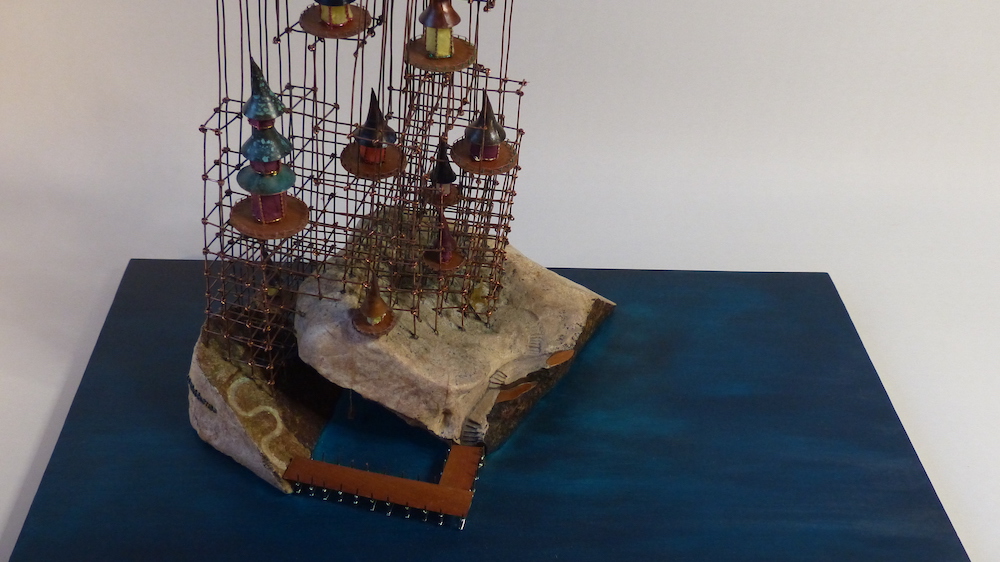 Island with colourful homes on a wire scaffold pier from above